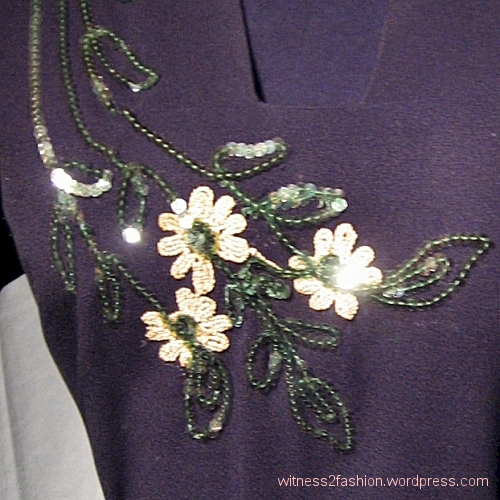Detail: a spray of flowers made from sequins on a vintage dress.
